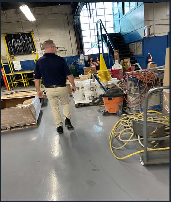 Worker walking through a commercial floor preparation area