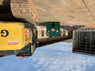 Excavator and debris staging at a construction site