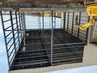 Steel building shell and excavator access
