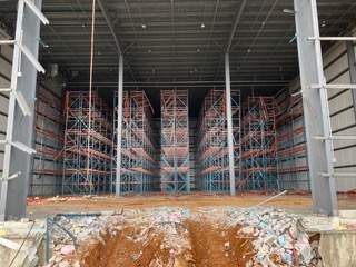 Warehouse construction with soil and equipment access at the entrance
